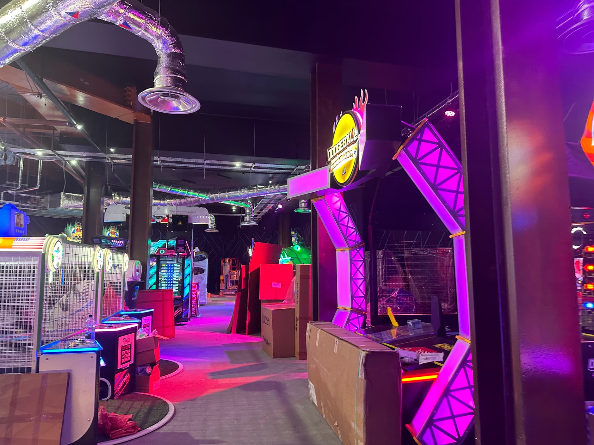 Illuminated dodgeball arena entrance frame inside an entertainment venue