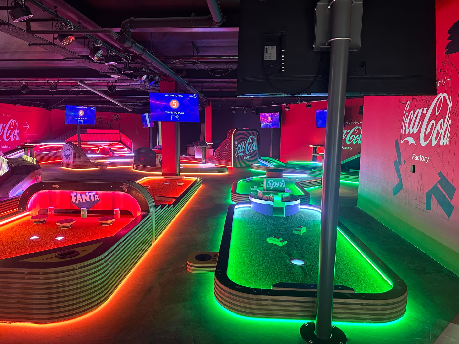 LED illuminated indoor mini golf holes with digital hole scoring screens overhead