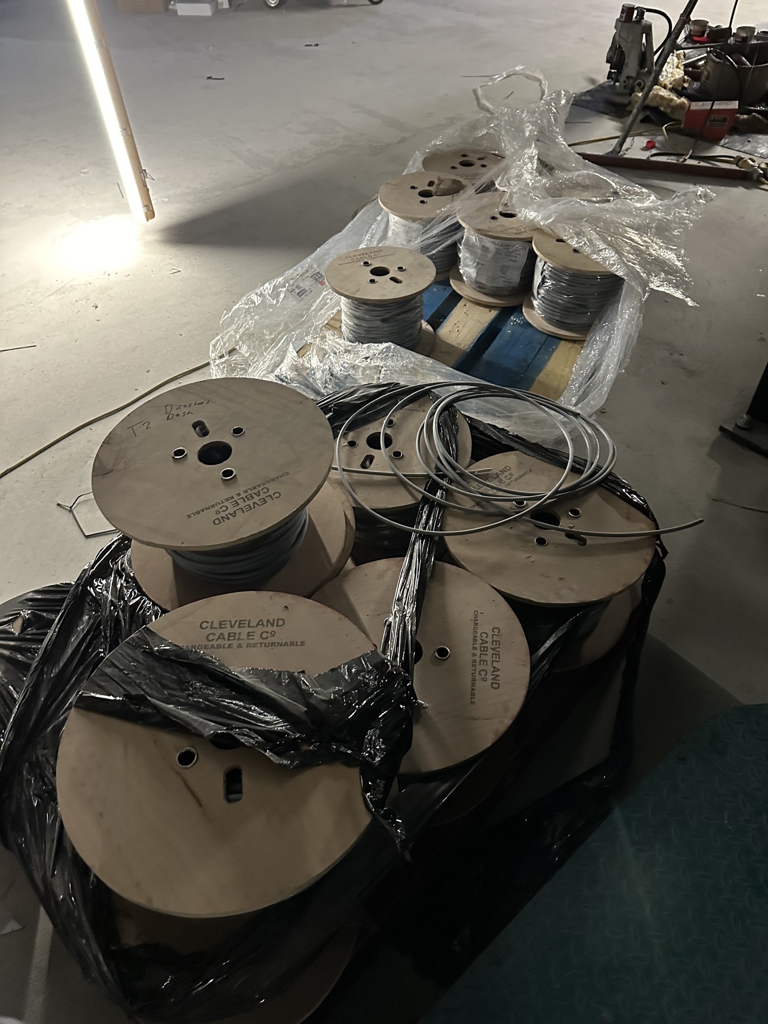 Pallets of Cleveland Cable Co cable drums set out in a site materials area