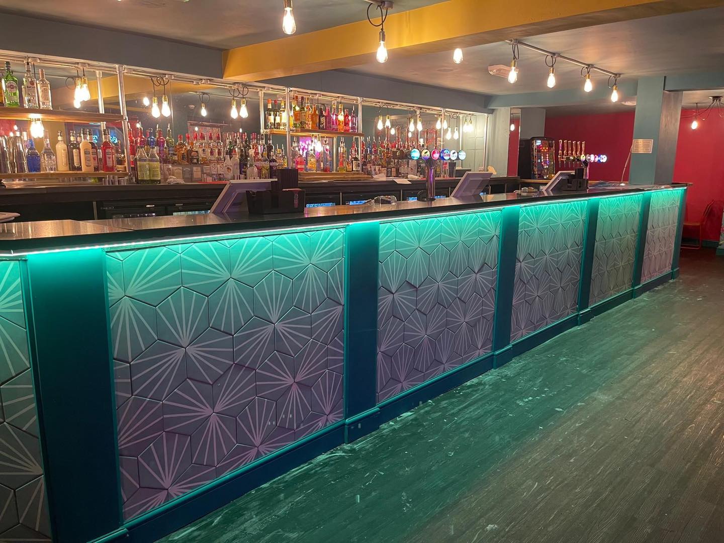 Tipsy Terrace bar in Cleethorpes with turquoise under-counter lighting and overhead filament pendants