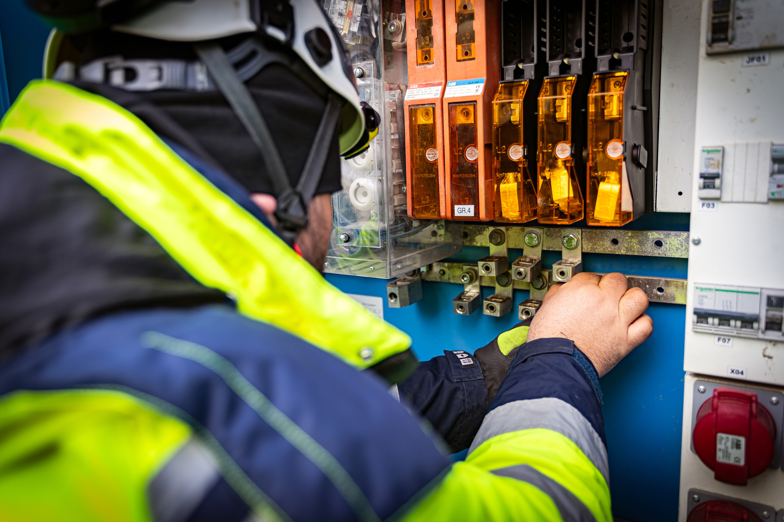 Electrical engineer inspecting industrial switchgear and power distribution equipment