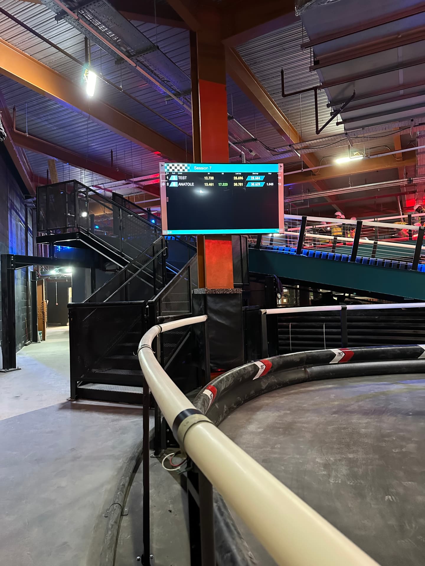 Wall mounted digital race timing display screen in a karting venue