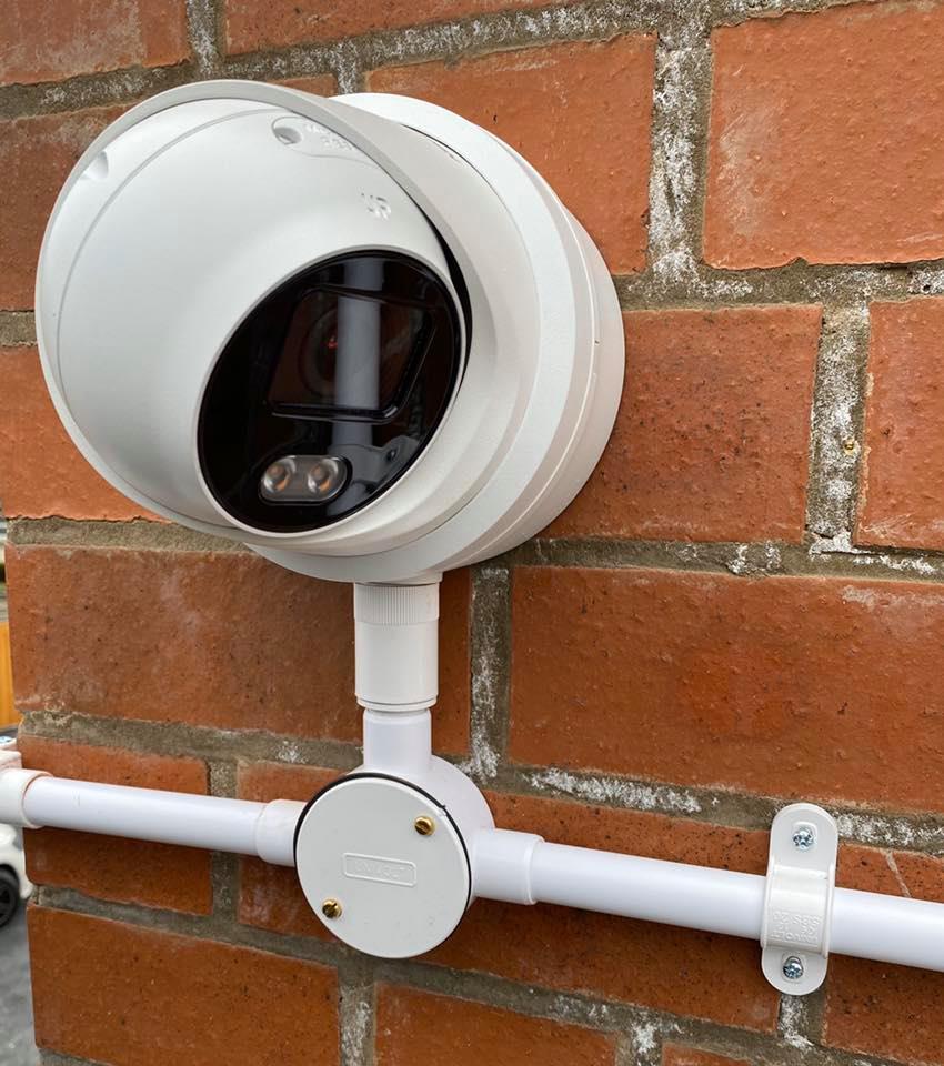 High definition turret CCTV camera installed on brickwork with neatly aligned external conduit